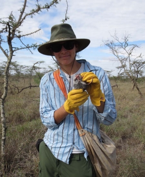 holding a pouched mouse in Kenya